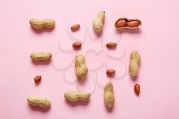 Tasty peanuts on color background�