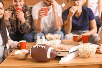 Group of fans watching rugby on TV�