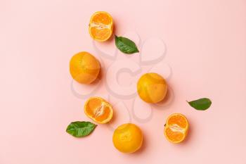 Ripe tasty tangerines on color background�