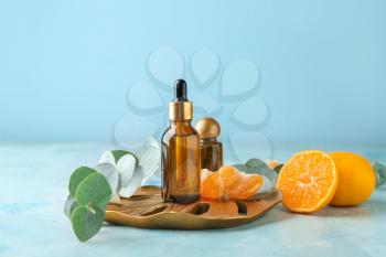 Bottles of tangerine essential oil on table�