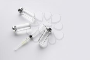 Syringe and ampules with filler for cosmetology on white background�