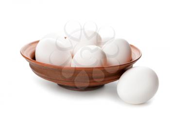 Bowl with fresh raw eggs on white background�