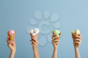 Female hands with sweet ice-cream on color background�