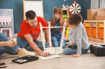 Family assembling furniture at home�