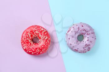 Sweet tasty donuts on color background�