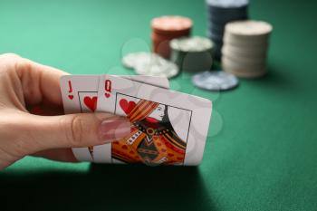 Woman playing poker in casino, closeup�
