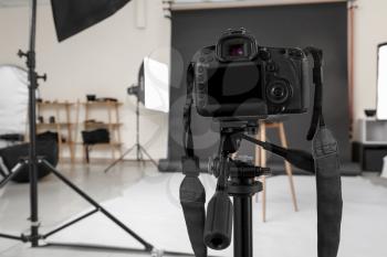 Modern camera in professional photo studio�