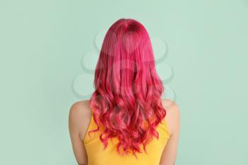 Beautiful young woman with unusual hair on color background�