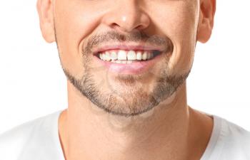 Handsome man with healthy teeth on white background, closeup�