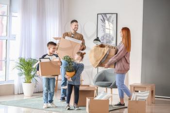 Family with moving boxes in their new house�
