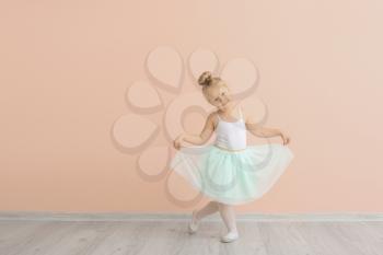 Cute little ballerina near color wall�