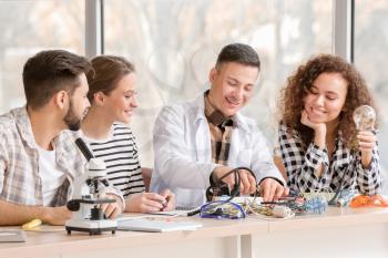 Young people at physics lesson in classroom�