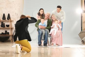 Photographer working with family in studio�