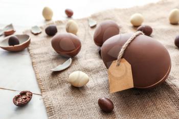 Tasty chocolate Easter eggs on wooden background�