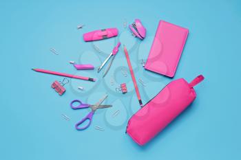 Pencil case and stationery on color background�