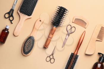 Set of hairdresser's accessories on color background�