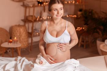 Young pregnant woman resting in spa salon�