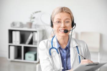 Female doctor giving a consultation online in clinic�