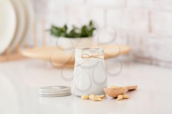 Jar of tasty cashew milk on table�