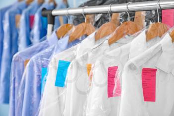 Rack with clothes after dry-cleaning, closeup�