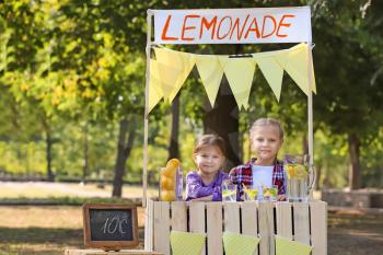 Little girls at lemonade stand in park�