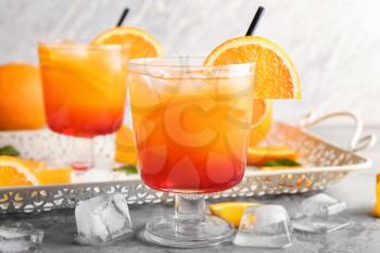 Fresh summer cocktail in glass on grey table�