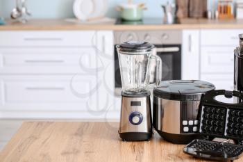 Different household appliances on table in kitchen�