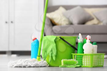 Set of cleaning supplies on floor in room�
