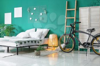Interior of modern bedroom with bicycle�