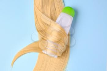 Bottle of shampoo for blonde hair on color background�