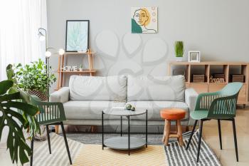 Stylish interior of living room with sofa�