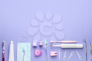 Set for oral hygiene with medical mask on color background�