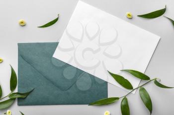Composition with blank card and envelope on light background�