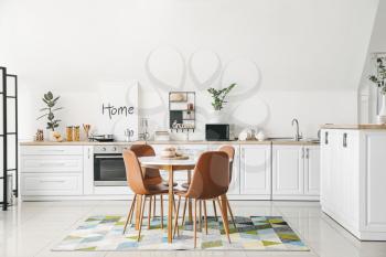 Interior of stylish modern kitchen with dining table�