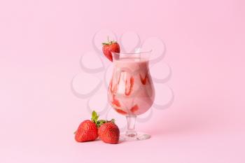Glass of tasty strawberry smoothie on color background�