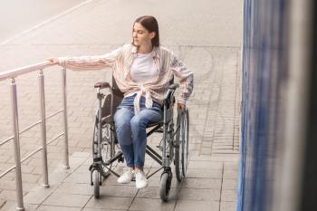 Young woman in wheelchair outdoors�