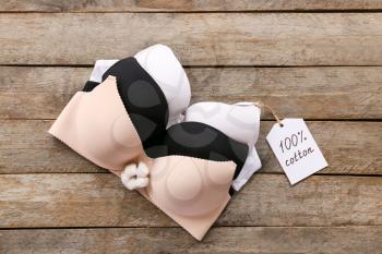 Cotton bras on wooden background�