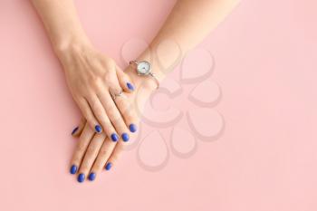 Hands with beautiful manicure on color background�