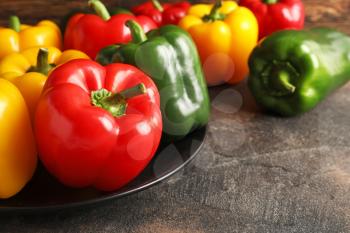 Fresh bell peppers in plate on table�