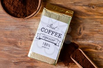Pack and bowl with coffee on wooden background�