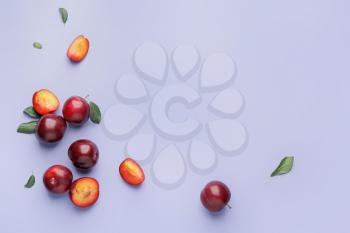 Fresh ripe plums on  color background�
