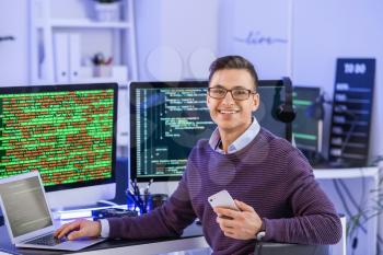 Portrait of male programmer in office at night�