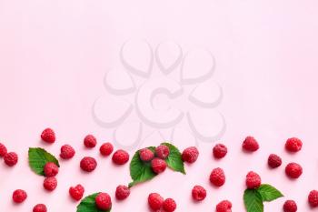 Tasty ripe raspberries on color background�