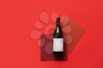 Bottle of wine with blank label on color background�