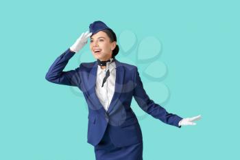 Beautiful stewardess on color background�