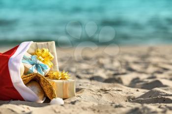 Santa Claus bag with gifts on beach�