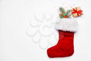Christmas sock with gifts on white background�