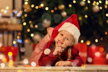 Cute little girl writing letter to Santa at home 