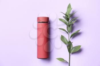 Modern thermos on color background�