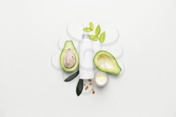 Composition with natural cosmetic products and avocado on white background�